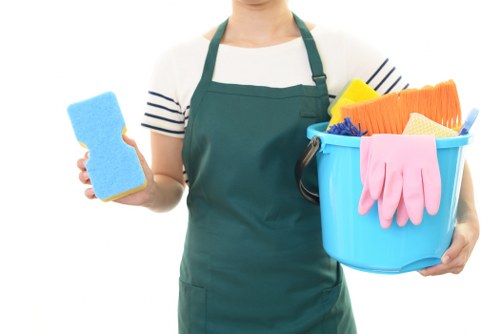 Cleaner carrying out regular home cleaning in a Sutton living room