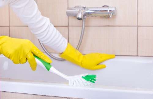 Cleaner working in a Sutton kitchen during a domestic visit