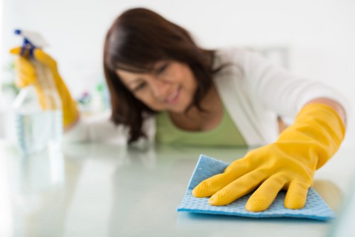 Cleaning desks and meeting rooms in a Sutton workplace
